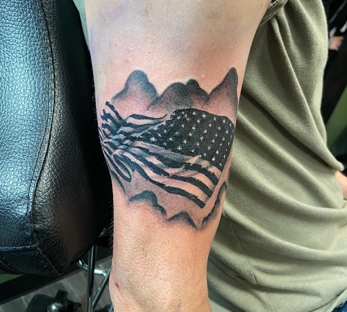 American flag tattoo with mountains