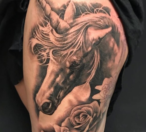 Black and gray unicorn tattoo with roses