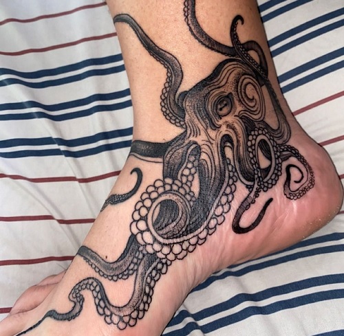 Black octopus tattoo on an ankle