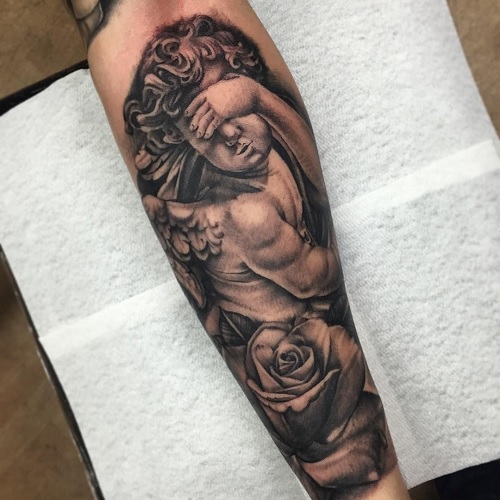 Blind cherub tattoo with a rose