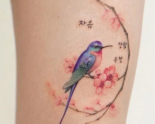Hummingbird and cherry blossom tattoo