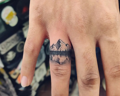 Mountain tattoo on a finger