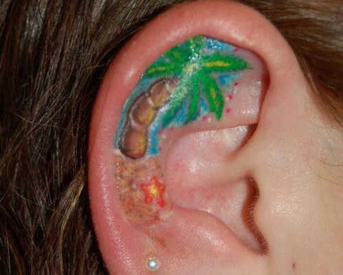 Palm tree tattoo in the ear