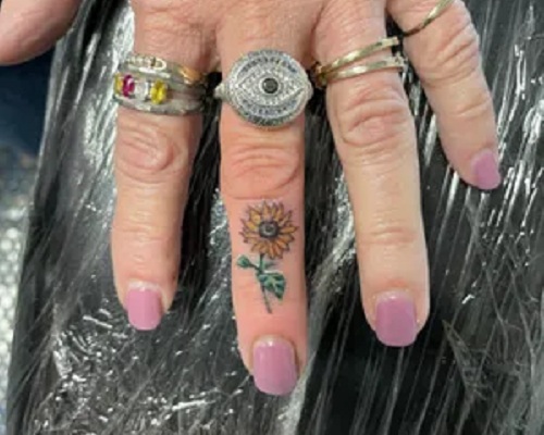 Sunflower tattoo on a finger